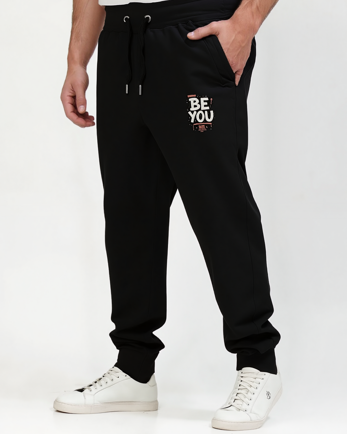 Black jogger pants with 'BE YOU' text on a white background