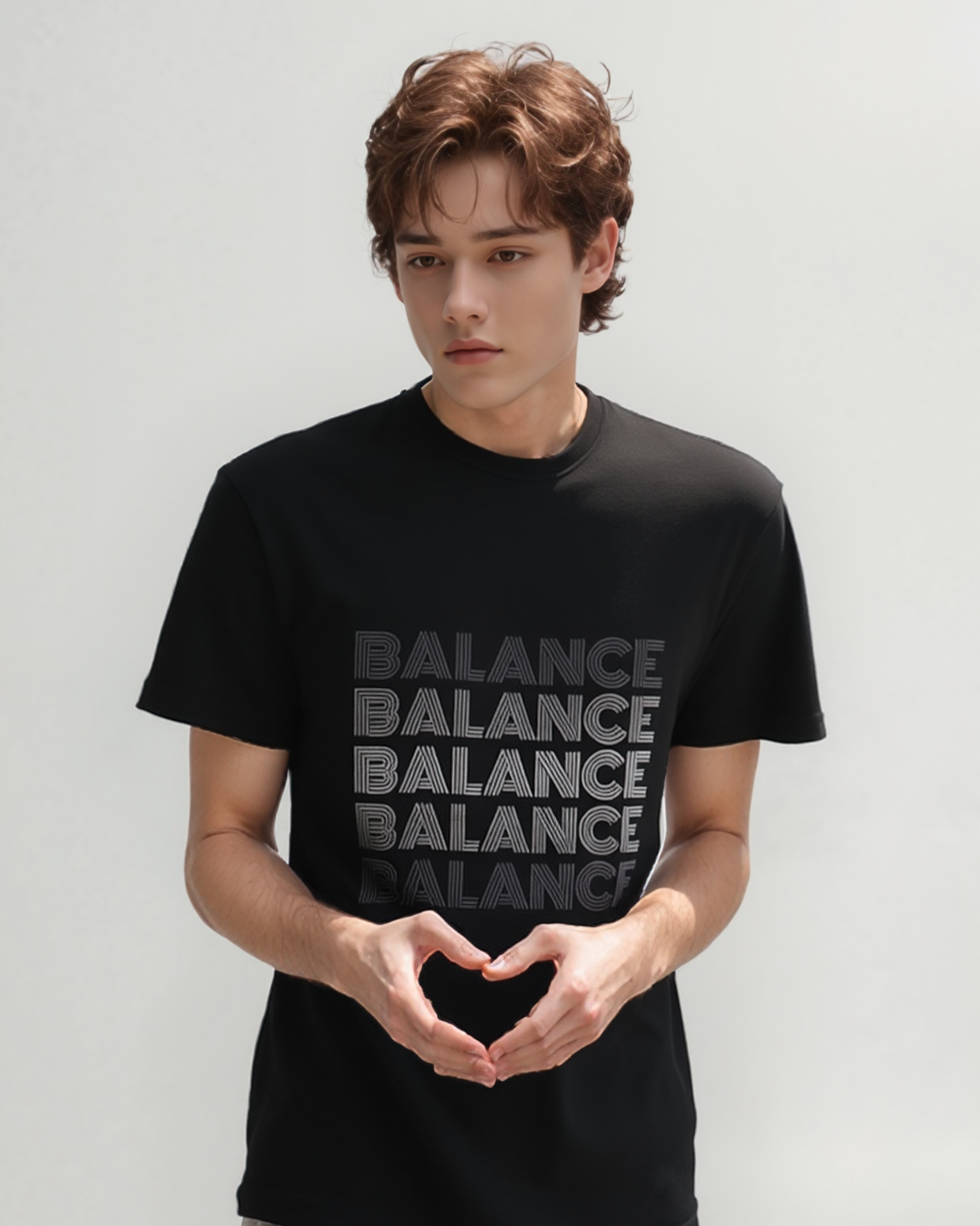 Person wearing a black t-shirt with 'BALANCE' text on a plain background