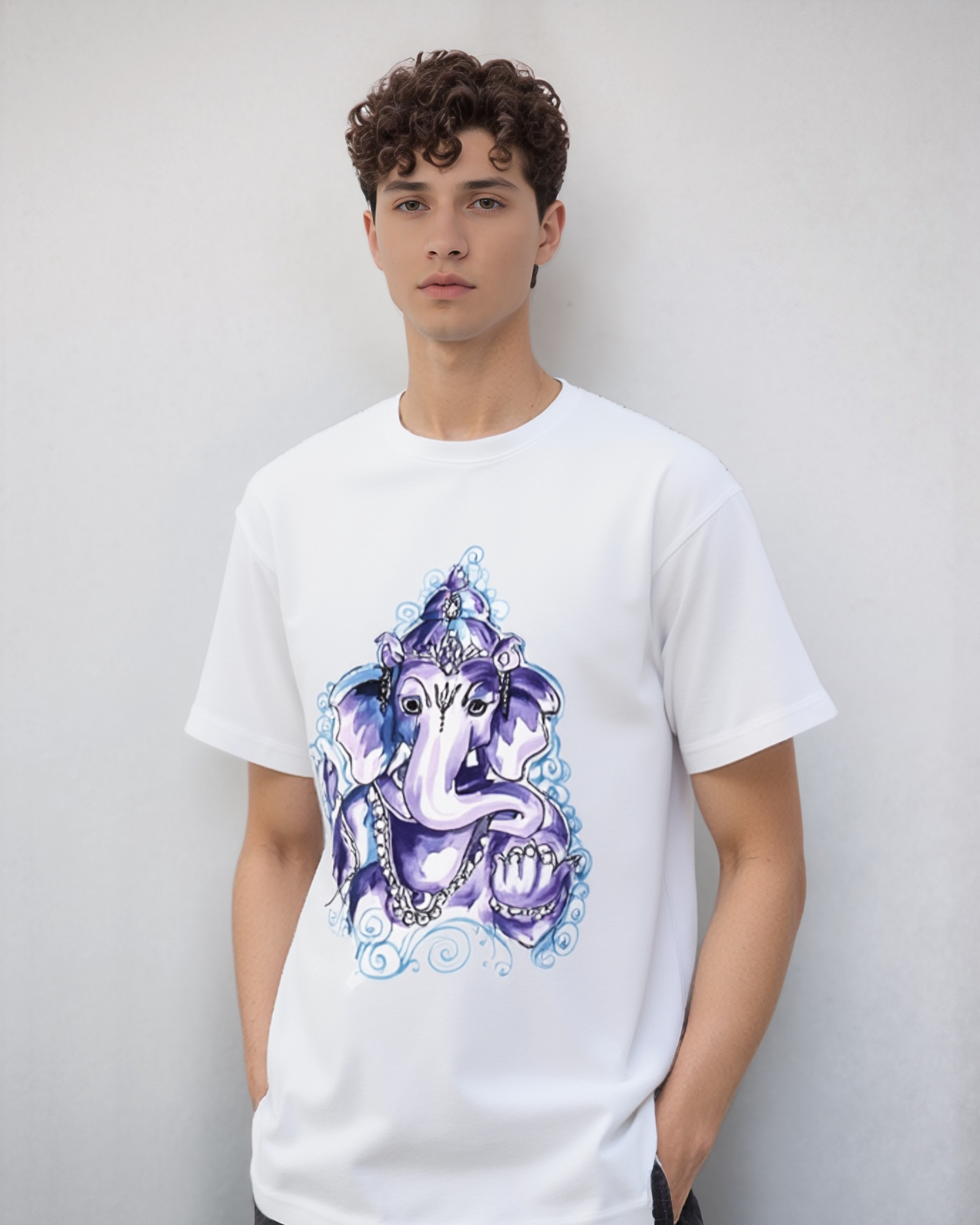 Person wearing a white t-shirt with a colorful graphic design against a plain background