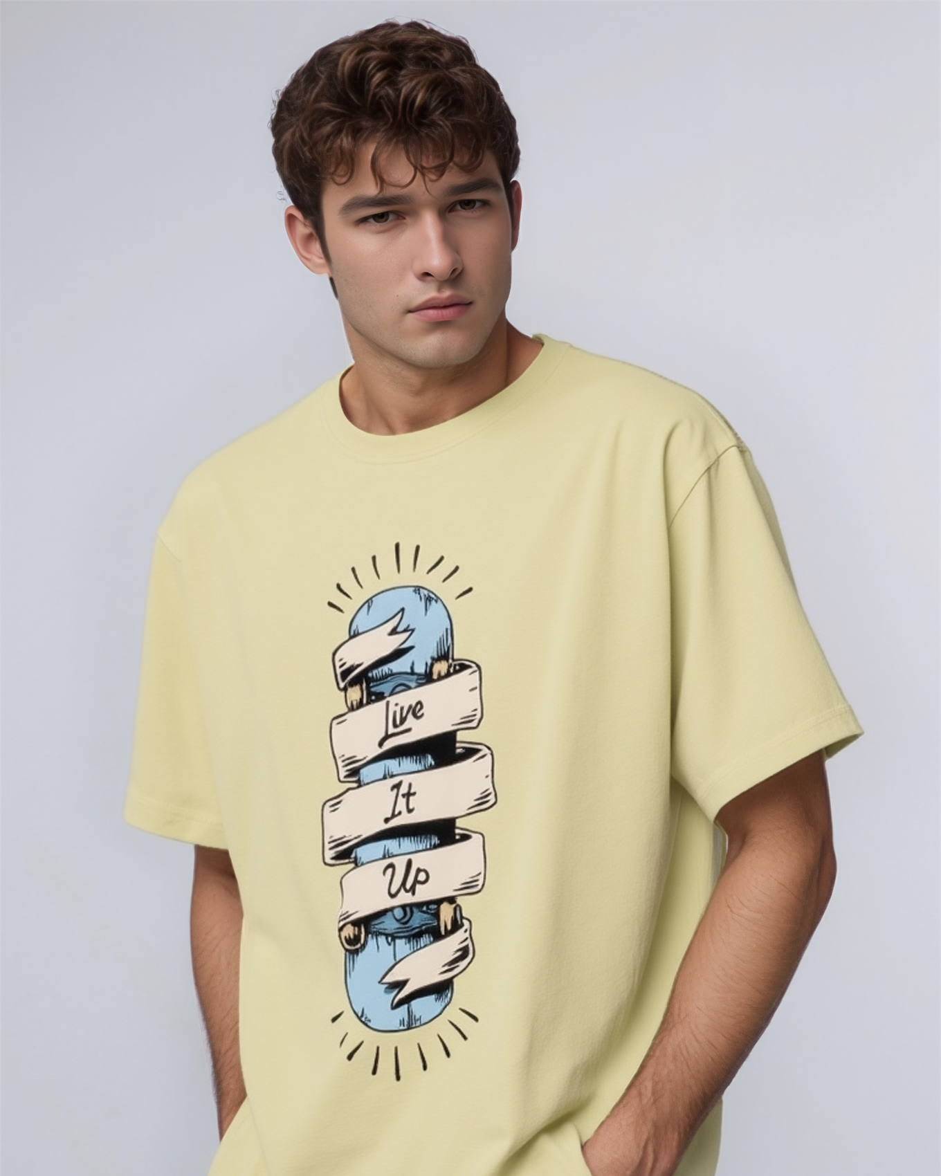 Man wearing a light yellow t-shirt with a graphic design on a plain background