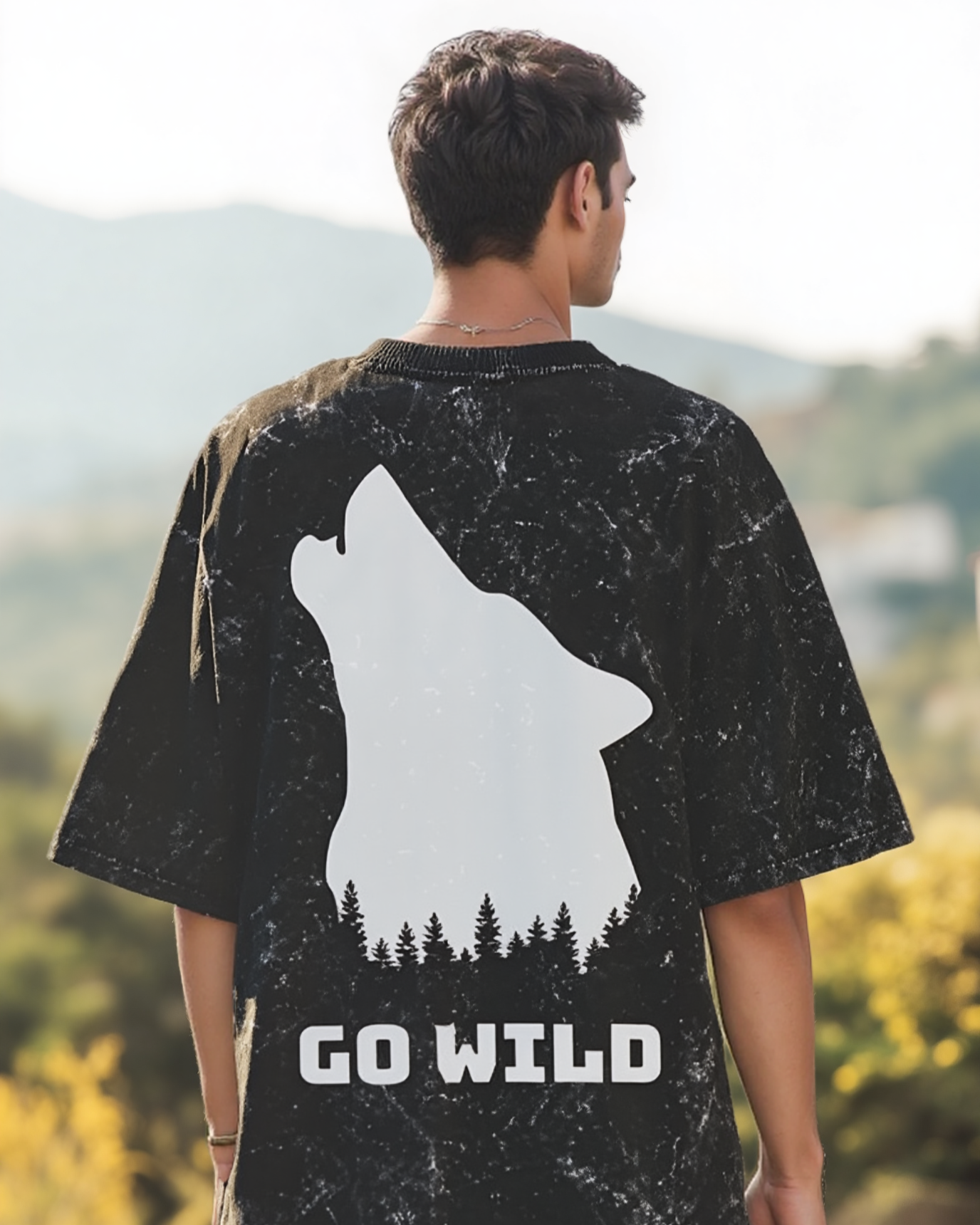 Person wearing a black t-shirt with a white wolf graphic and 'GO WILD' text, standing outdoors.